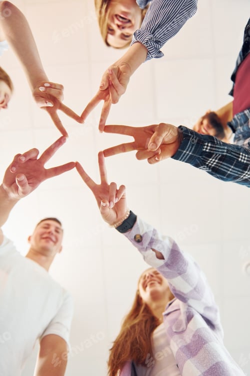Preview: Making gesture by hands. Group of friends standing together