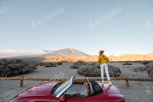 Preview: Woman traveling by car on the volcanic valley