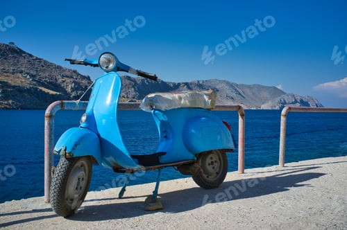 Preview: Beautiful seascape with a parked motorcycle in the foreground in Symi greek island