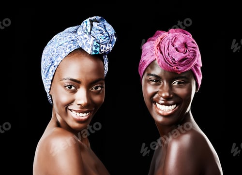Preview: Studio portrait of two beautiful women wearing headscarves against a black background
