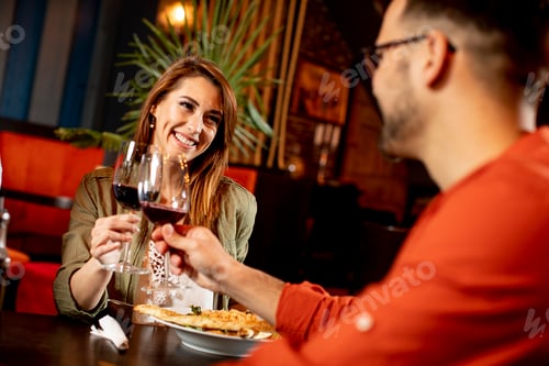 Preview: Young couple enjoying lunch in the restaurant