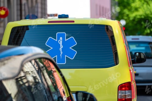 Preview: a yellow ambulance emergency car parked on the side of a crowded street, close up, selective focus