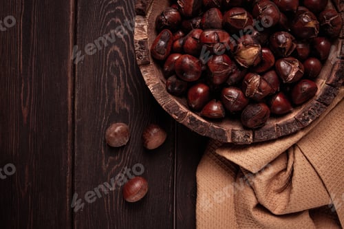 Preview: roasted chestnuts, in a wooden plate, top view, homemade, no people,