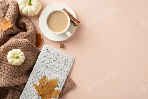 Preview: Cozy fall workplace concept. Top view with keyboard, comfy brown knitted sweater, fresh coffee