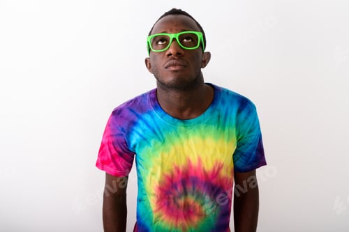 Preview: Studio shot of young black African man looking up against white