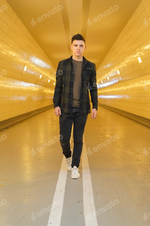 Preview: man walking in a tunnel looking at the camera