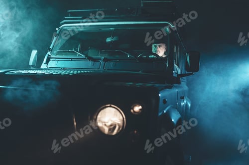 Preview: Focused Senior Middle Aged Guy Driving His Vintage 4X4 Vehicle Alone On A Fuzzy Dark Night.