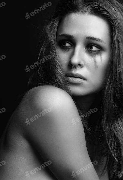 Preview: Young Pretty Woman With Smeared Mascara Crying On Black Background