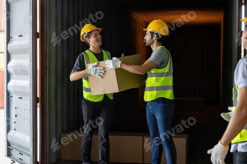Preview: Worker carry carton box taken from 40 feet steel container on the trailer truck park at warehouse