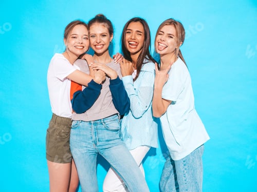 Preview: Portrait of four funny beautiful women posing in studio