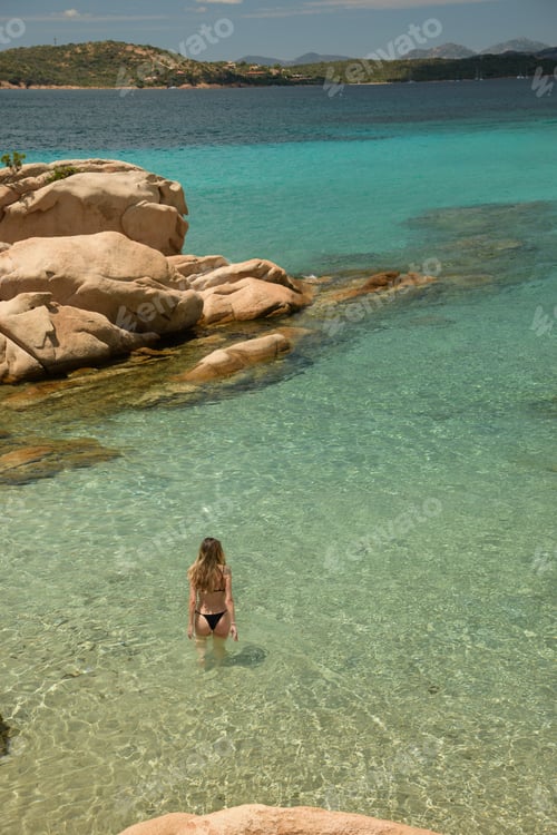 Preview: Tourist enjoying crystal clear water in sardinia, italy during summer holidays