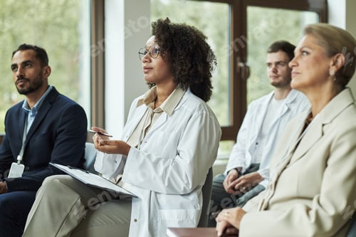 Preview: Diverse Group of Medical Professionals Attending Seminar in Conference Room