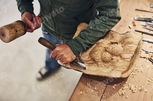 Preview: He can carve just about anything. Cropped shot of an artist carving something out of wood.