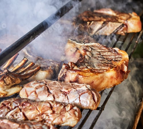 Preview: Grilled steaks and ribs cooking on barbecue