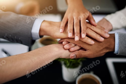 Preview: Closeup shot of a diverse team of colleagues joining their hands together in unity