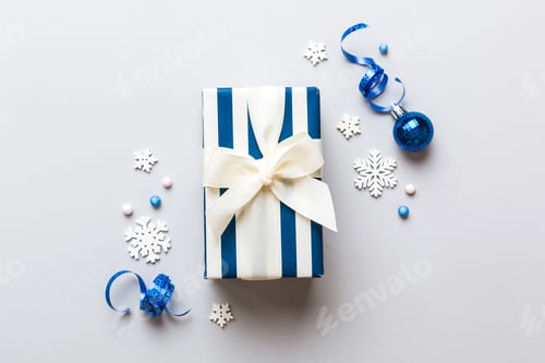Preview: Top view Flat lay Christmas decorations and gift box on colored background