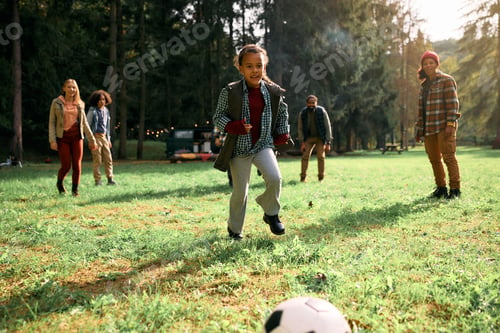 Preview: Playful black girl enjoying in camping day with her family and friends.