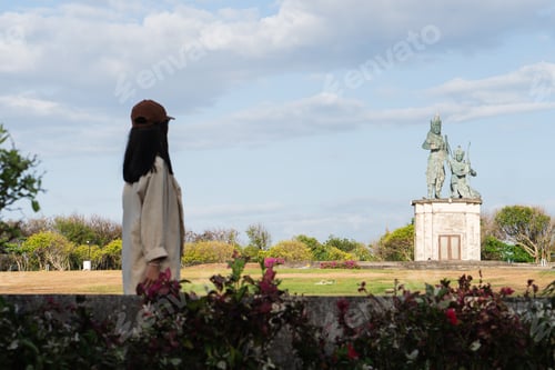Preview: Woman Admiring Historical Statue in Park