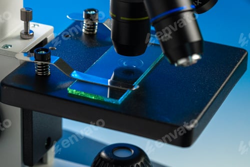 Preview: Close up photo of a microscope lenses examining glass sample