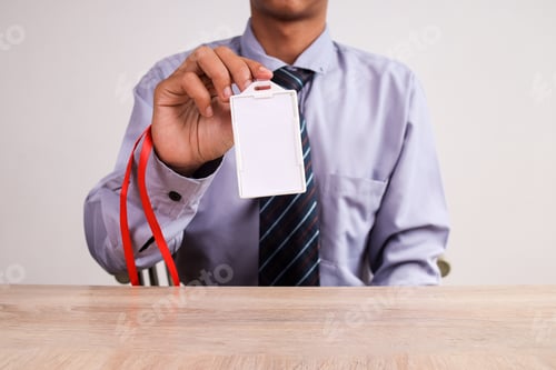 Preview: Businessman Holds Up A Blank ID Badge, Ready For Customization