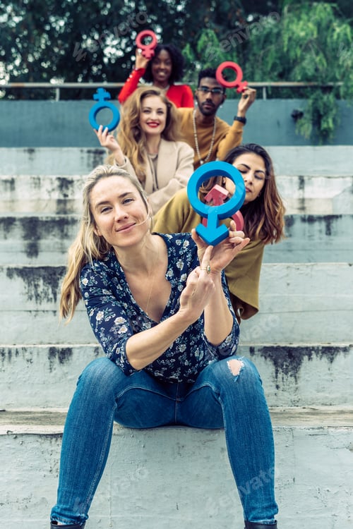 Preview: A blonde woman points her finger at a male symbol