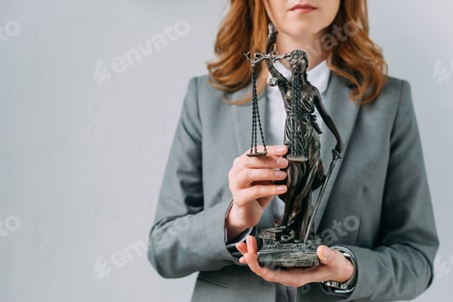 Preview: Cropped view of female lawyer holding themis figurine on grey