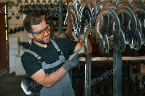 Preview: Quality test. Man in uniform is in workstation developing details of agriculture technique