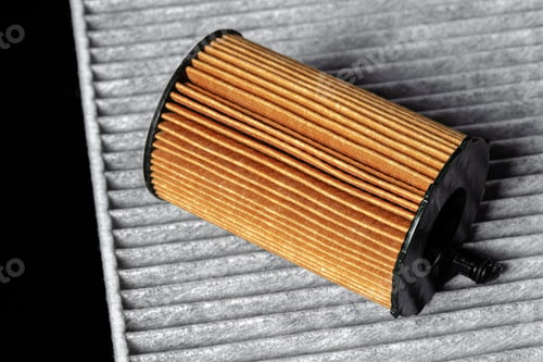 Preview: Car engine filter on dark background, close up.