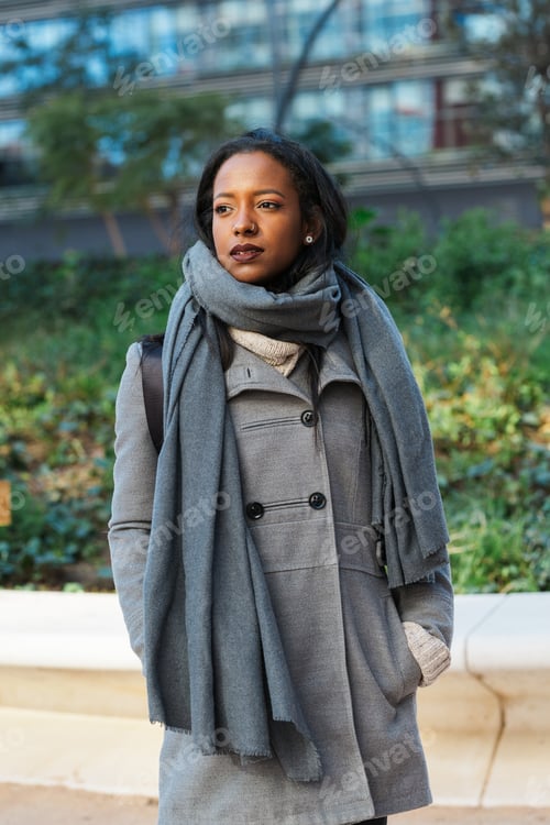 Preview: Professional business woman looking away while standing on the street at financial district
