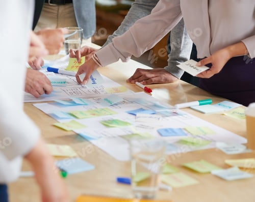 Preview: Multi Racial people in brainstorming session with post it notes on desk