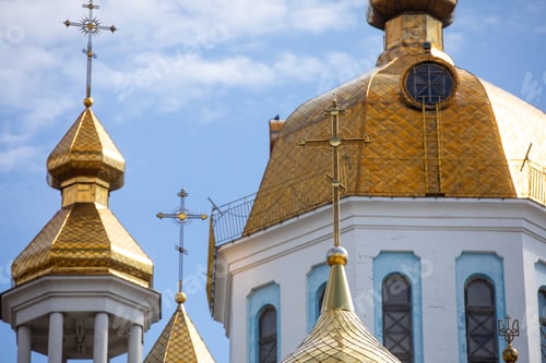 Preview: The golden domes and the crosses of the Orthodox church against the blue sky and clouds
