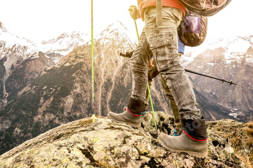 Preview: Close up of trekking legs and boots on french alps