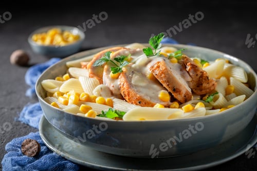 Preview: Pasta with chicken, corn and bechamel sauce on grey table