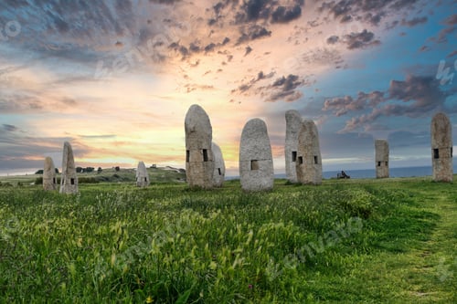 Preview: Menhires Pola Paz in a field under the sunlight during the sunrise in Spain