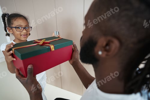 Preview: Adult African American father is giving gift to his daughter