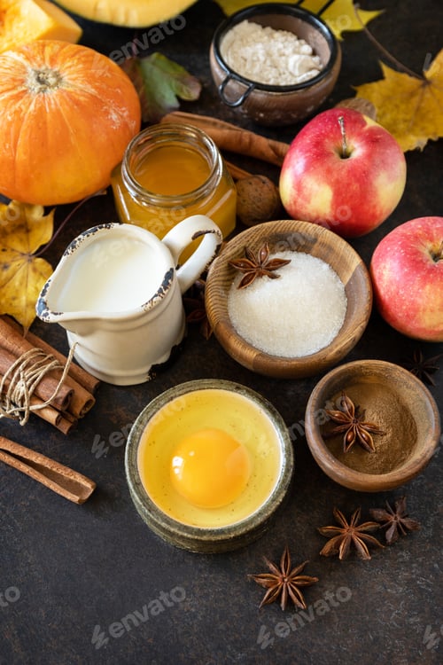 Preview: Autumn baking food background with pumpkins, apples, honey, nuts and seasonal spices.