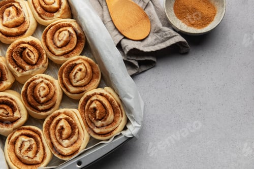 Preview: Cinnamon rolls prepared for baking with brown sugar and wooden spoon