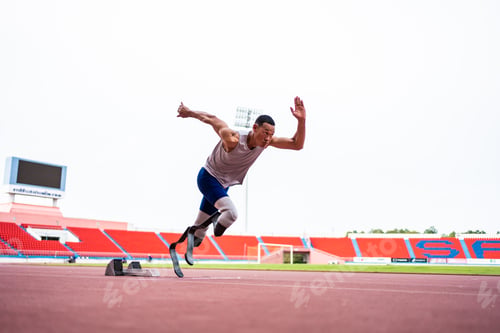 Preview: Asian para-athletes disabled with prosthetic blades running at stadium.