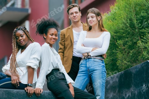 Preview: creative marketing team of young diverse professionals standing together outdoors