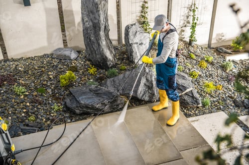 Preview: Worker Cleaning the Yard Around the House