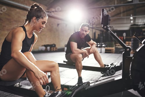 Preview: Two sportsmen preparing to workout rowing machines