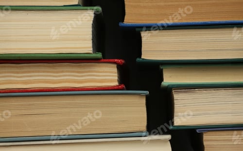 Preview: Open book, hardback colorful books on table. Back to school. Copy space for text. Education business concept.