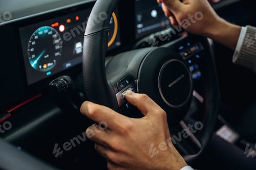 Preview: Driving, holding steering wheel. Man is sitting in car, detailed view