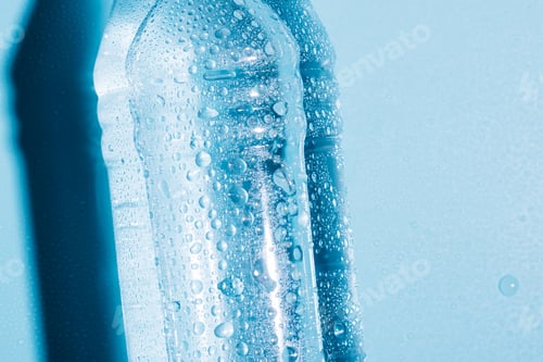 Preview: Plastic bottles with water and empty used blue background. Recycling recyclable plastic
