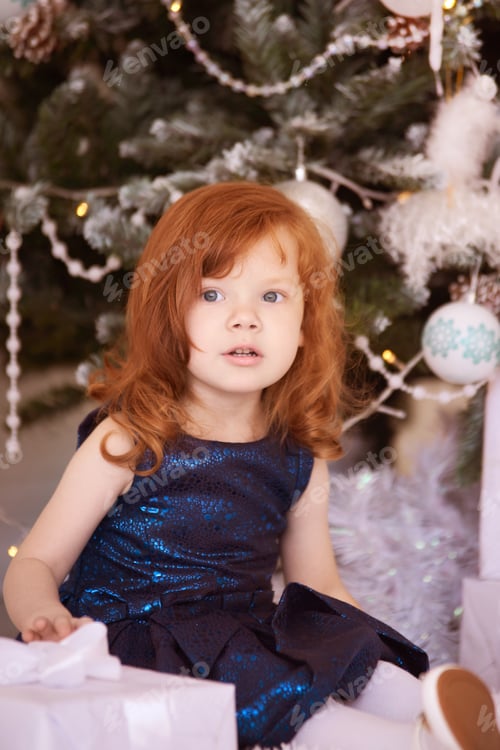 Preview: Young Girl Smiling at Christmas with Gift Boxes