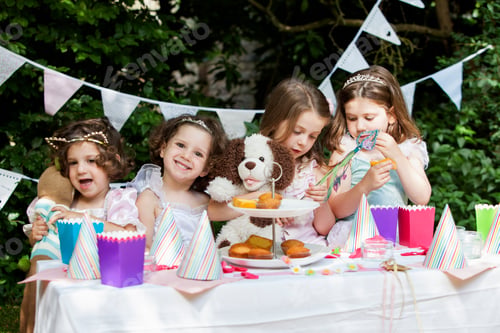 Preview: Group of young girls dressed up at a garden party.