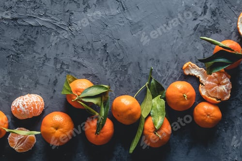Preview: Juicy ripe tangerines with leaves on wooden table
