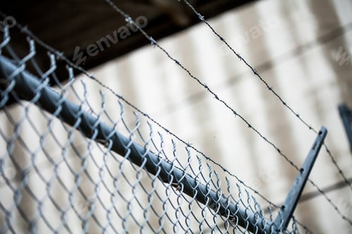 Preview: Outdoor Fence Detail of Sharp Barbwire Installation.