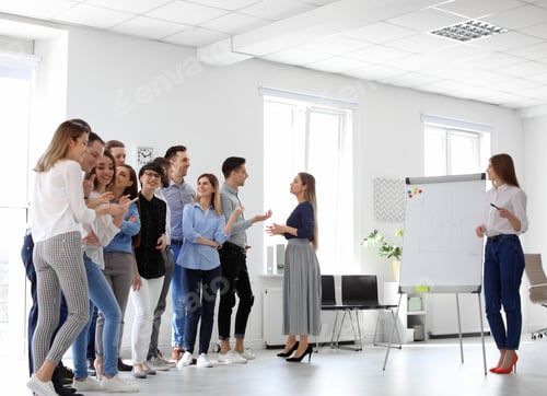 Preview: Female business trainer giving lecture in office