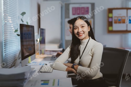 Preview: Asian woman working late creating UX UI designs